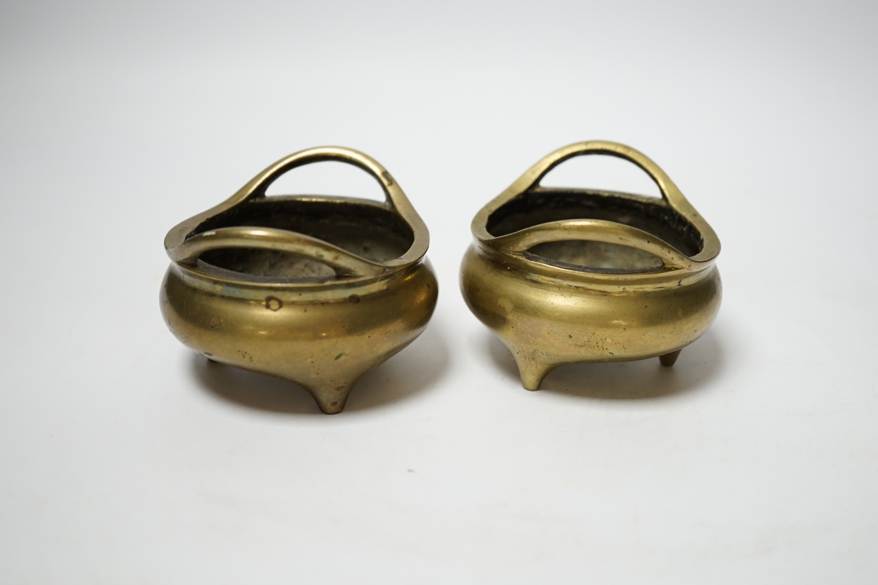 A pair of late 19th/early 20th century Chinese bronze censers, 8.5cm handle to handle